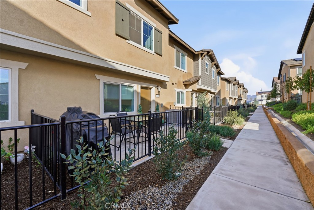 19210 Ash Grv Street Riverside, CA 92507 - Photo 3 of 38 a view of a brick house with wooden fence