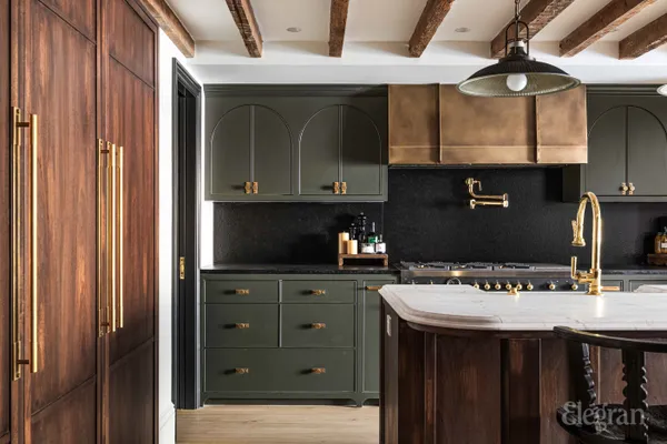 a kitchen with a stove a refrigerator and a dining table