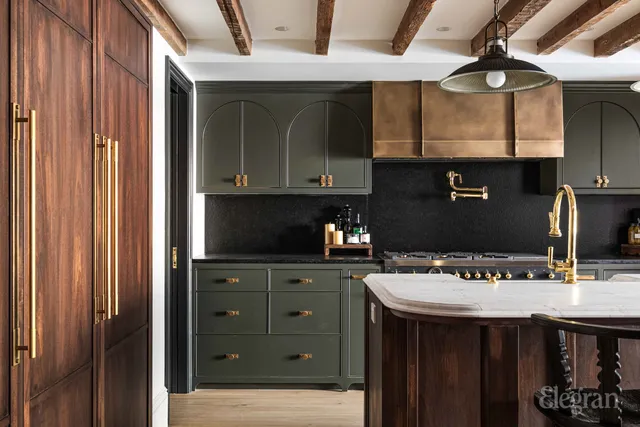 a kitchen with a stove a refrigerator and a dining table