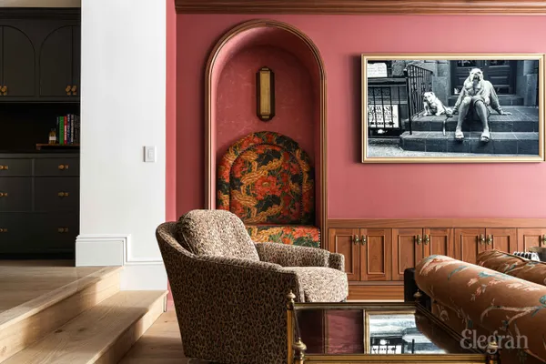 a living room with furniture and painting on the wall