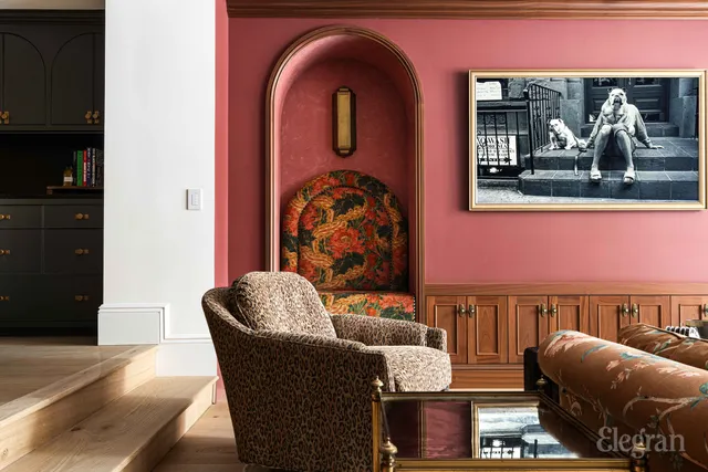 a living room with furniture and painting on the wall