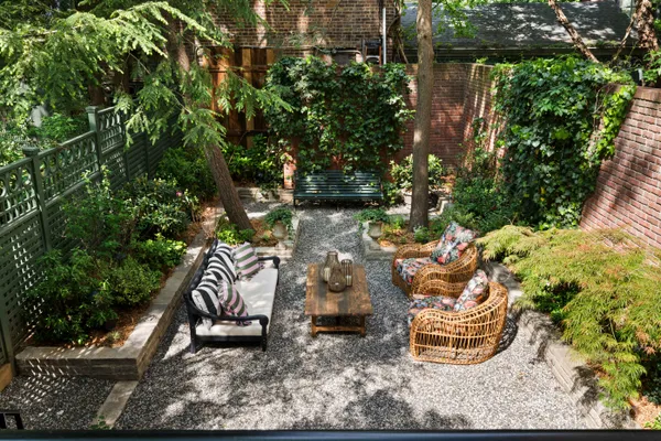 a backyard of a house with outdoor seating