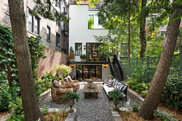 a view of a balcony with chairs and a potted plant