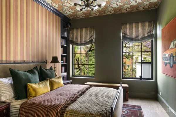 a bed sitting in a bedroom next to a window