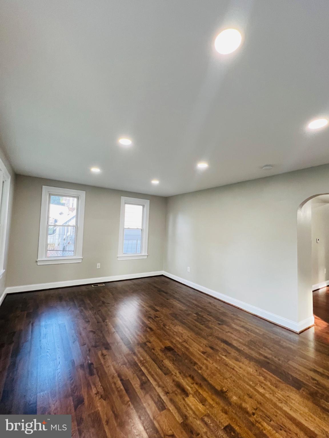 5709 Dade Street Capitol Heights, MD 20743 - Photo 13 of 30 an empty room with wooden floor and windows