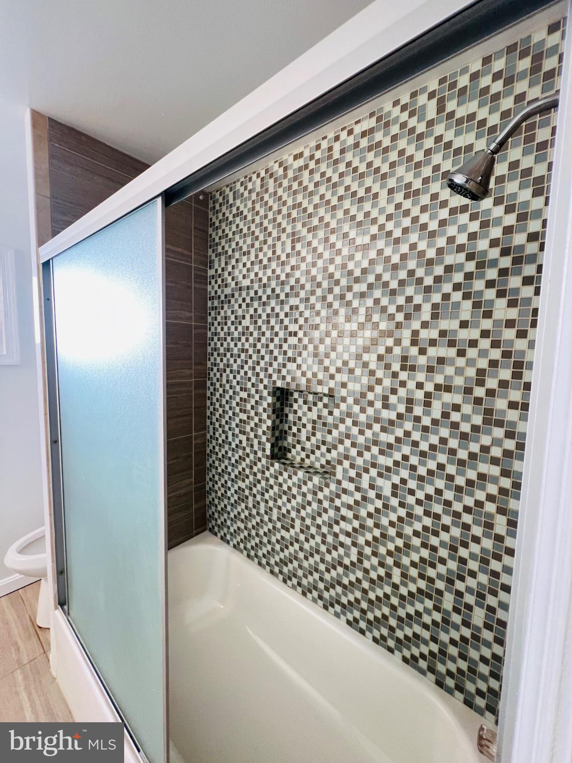 5709 Dade Street Capitol Heights, MD 20743 - Photo 21 of 30 a bathroom with a bathtub and shower