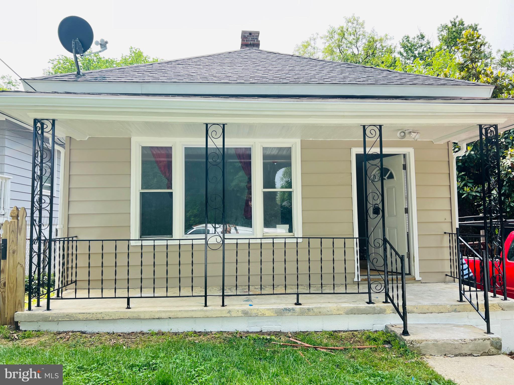 5709 Dade Street Capitol Heights, MD 20743 - Photo 29 of 30 a view of a house with a small yard and wooden fence