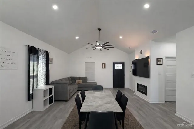 a view of a dining room with furniture a chandelier and wooden floor
