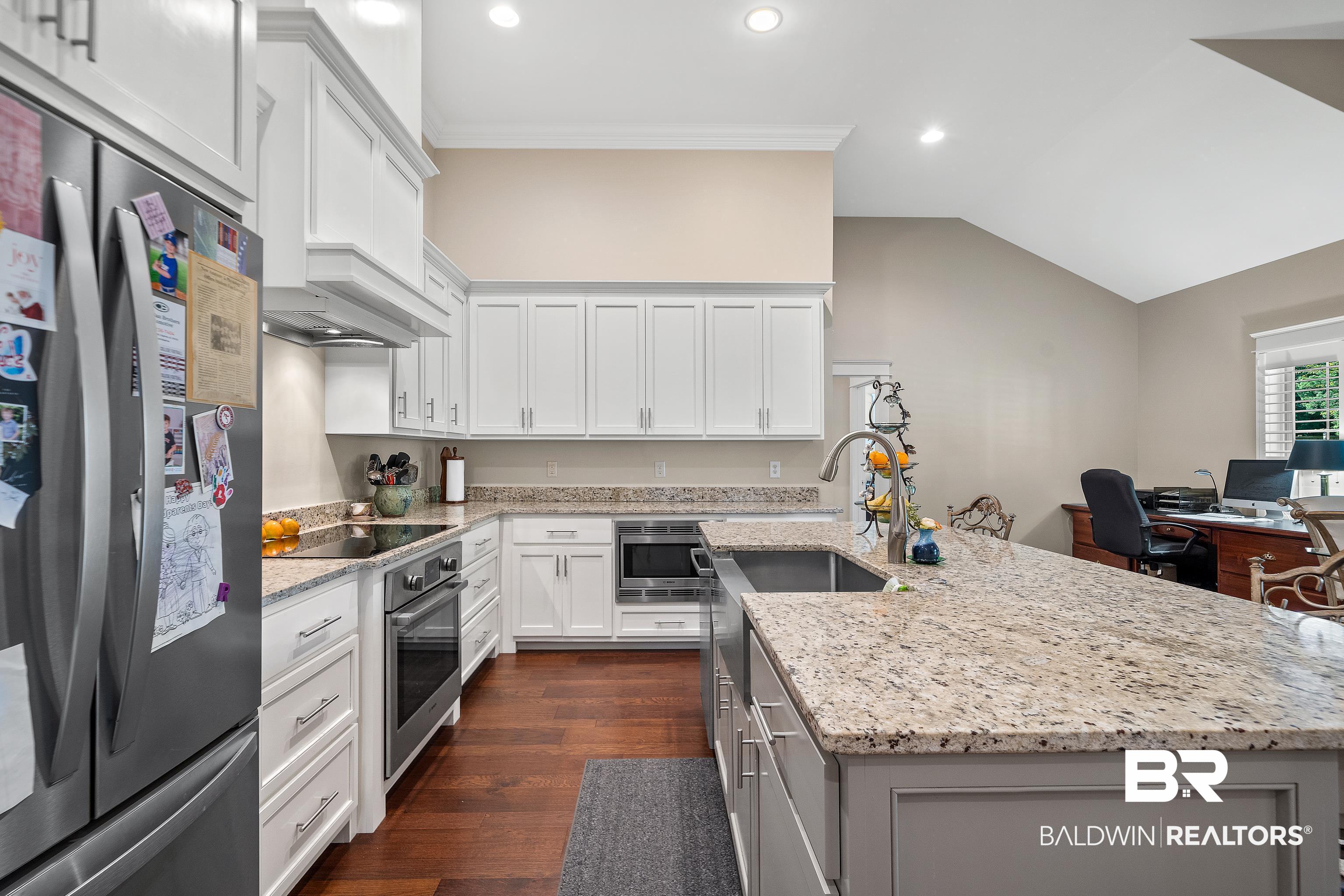 29530 St John Street Daphne, AL 36526 - Photo 7 of 38 Kitchen featuring sink, dark wood-type flooring, white cabinetry, stainless steel appliances, and vaulted ceiling
