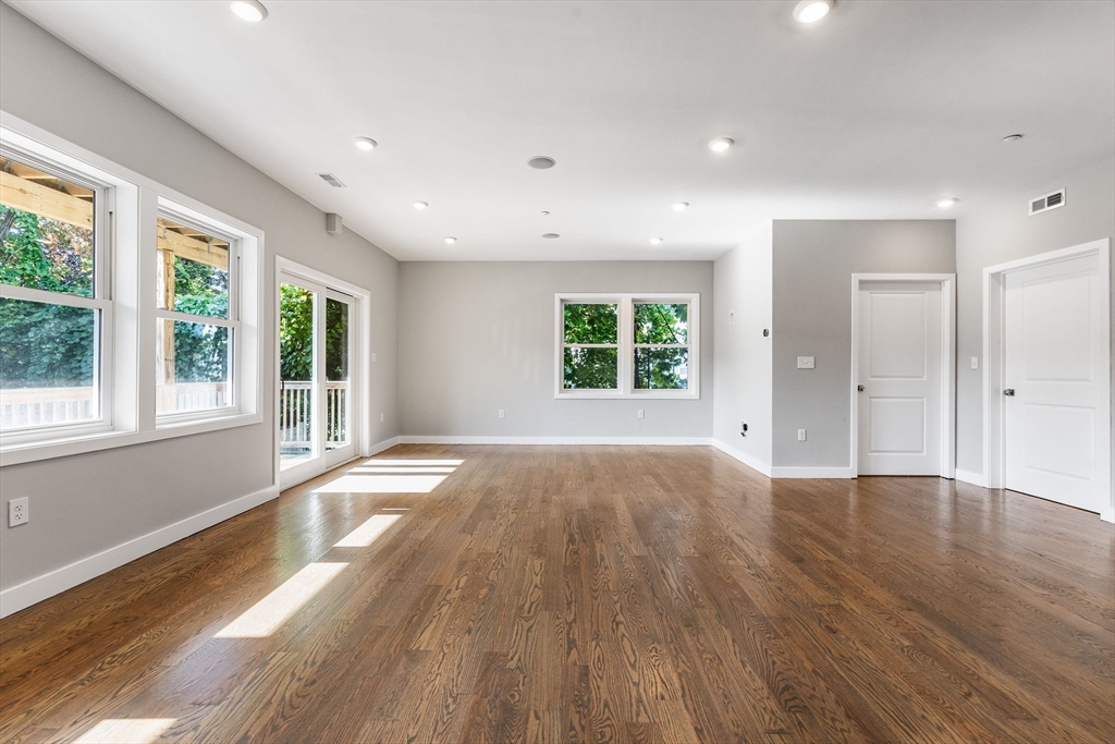 10 Ruthven Park, Unit 2 Boston, MA 02121 - Photo 13 of 25 a view of an empty room with a window and wooden floor