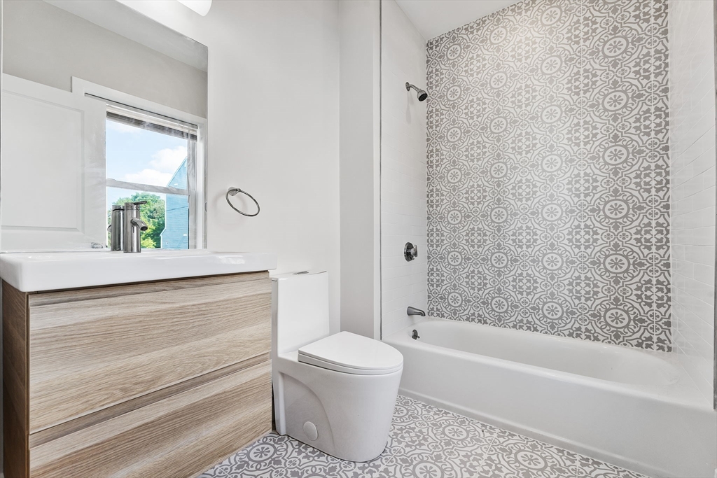 10 Ruthven Park, Unit 2 Boston, MA 02121 - Photo 20 of 25 a bathroom with a bathtub sink vanity mirror and toilet