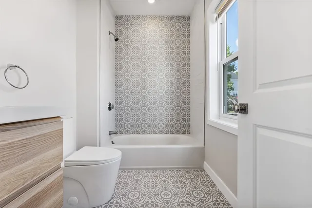 a bathroom with a bathtub and a shower