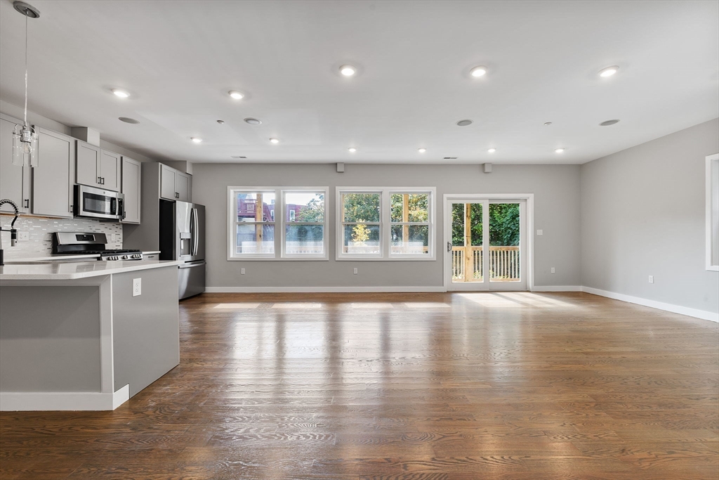 10 Ruthven Park, Unit 2 Boston, MA 02121 - Photo 6 of 25 a large kitchen with stainless steel appliances granite countertop a large counter top and a wooden floors