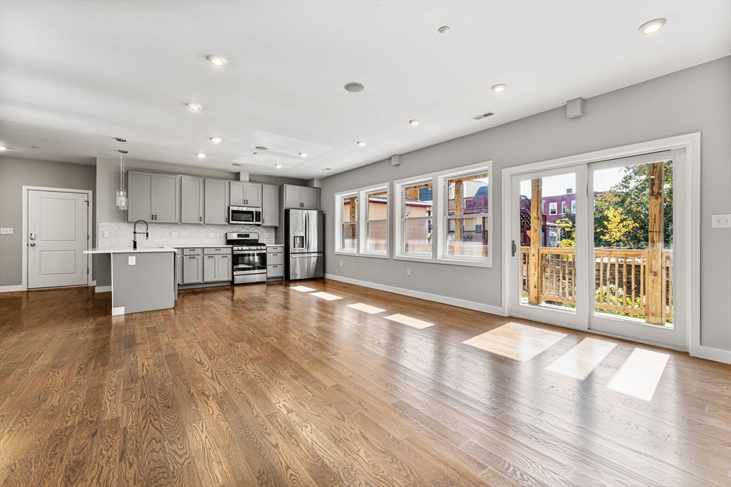 10 Ruthven Park, Unit 2 Boston, MA 02121 - Photo 8 of 25 a view of an empty room with a window and wooden floor