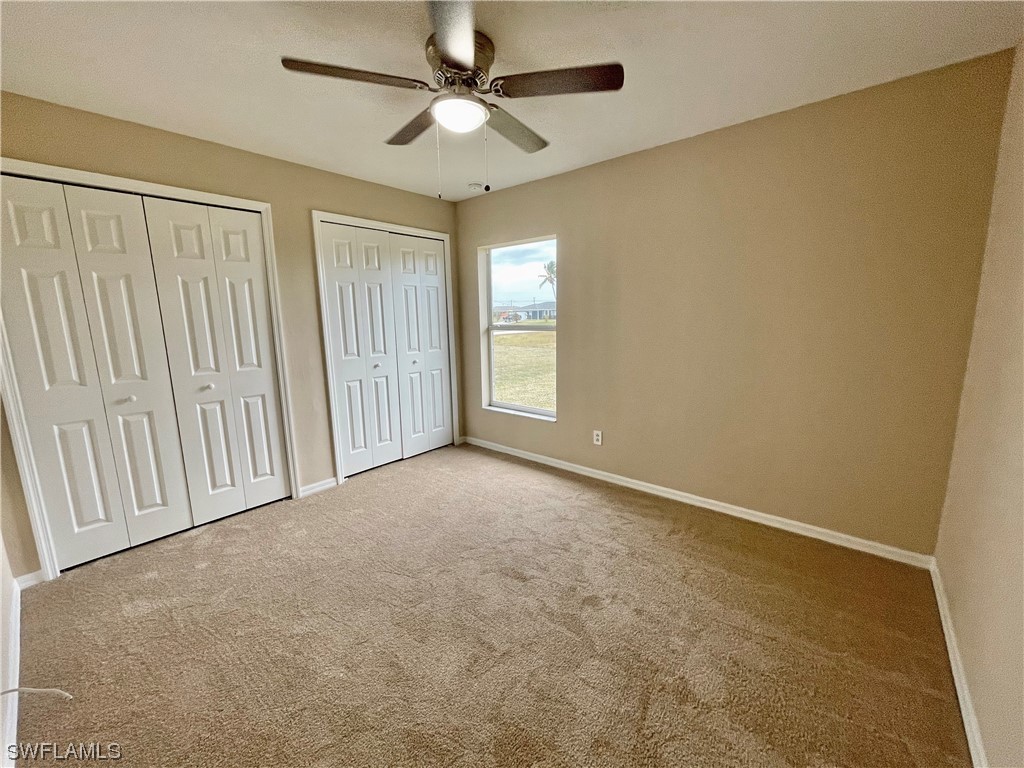 2804 Nelson Road North Cape Coral, FL 33993 - Photo 11 of 16 an empty room with windows and fan