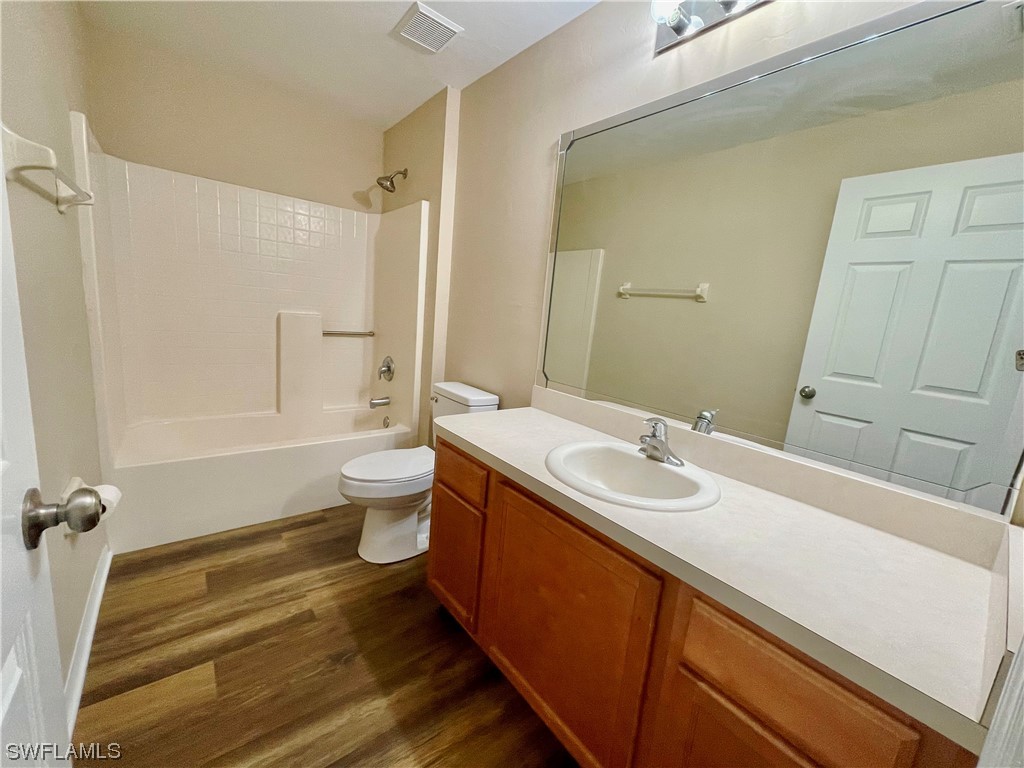 2804 Nelson Road North Cape Coral, FL 33993 - Photo 12 of 16 a bathroom with a sink and mirror with toilet