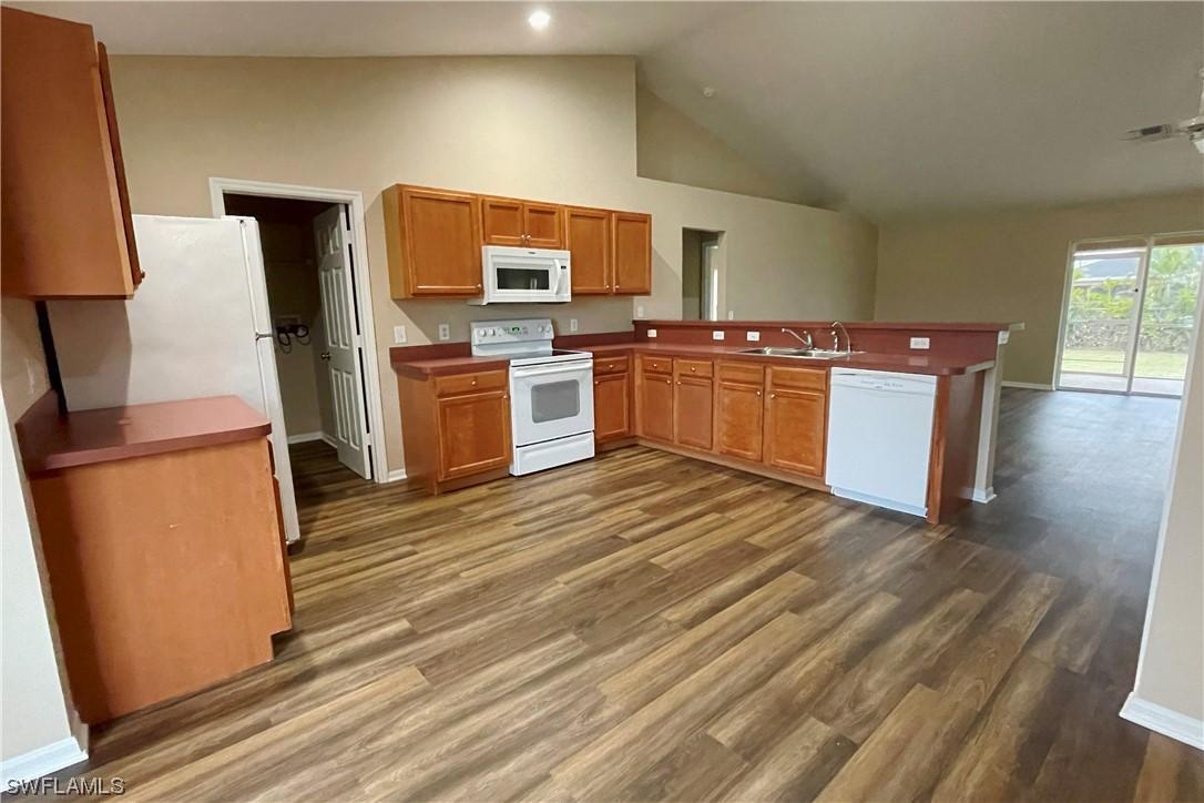 2804 Nelson Road North Cape Coral, FL 33993 - Photo 7 of 16 a kitchen with stainless steel appliances a stove top oven a sink and a refrigerator