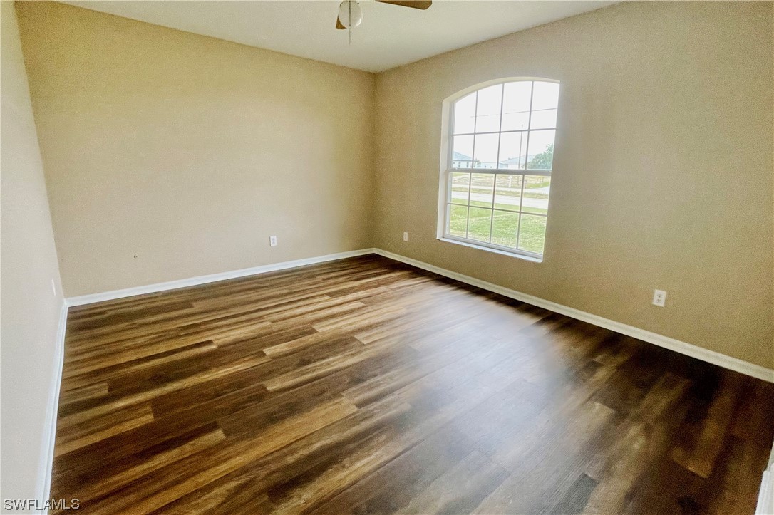 2804 Nelson Road North Cape Coral, FL 33993 - Photo 8 of 16 a view of an empty room with wooden floor and a window