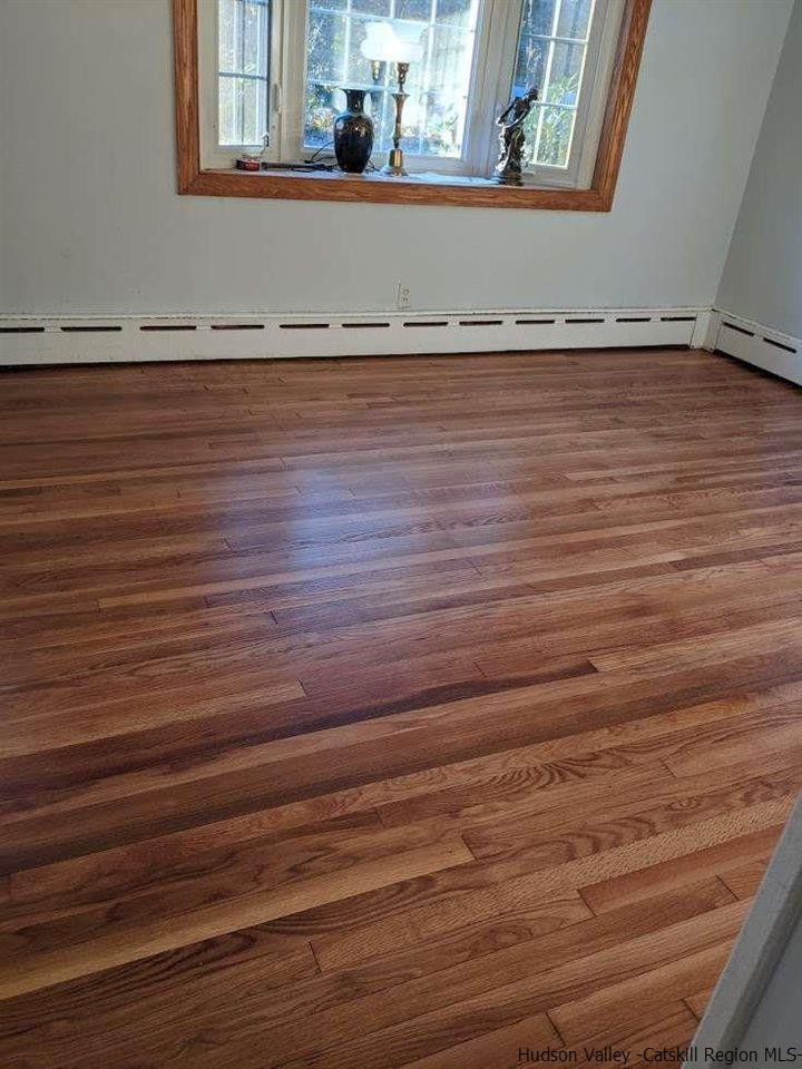 99 Grist Mill Road Tillson, NY 12486 - Photo 2 of 6 a view of a room with wooden floor and a window