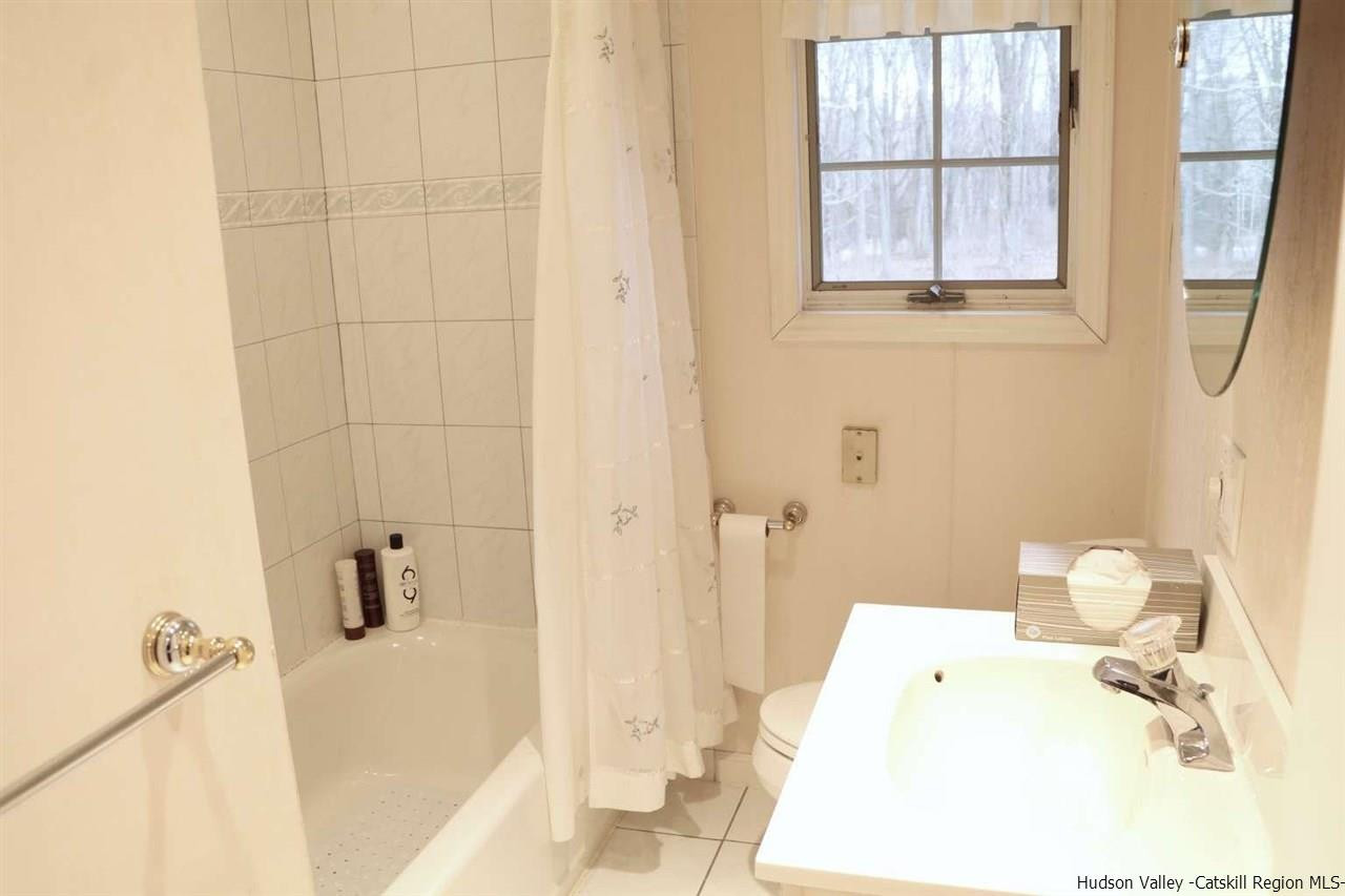 99 Grist Mill Road Tillson, NY 12486 - Photo 4 of 6 a bathroom with a sink and a toilet