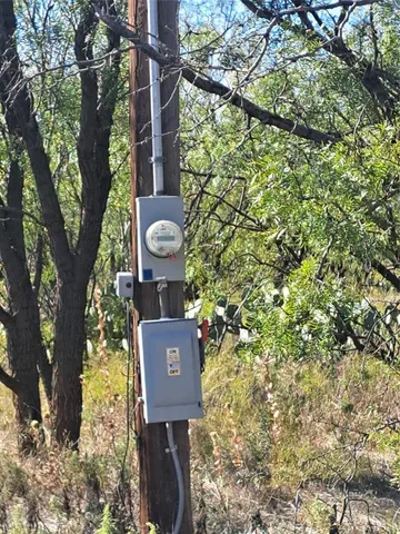 a sign board with tall trees