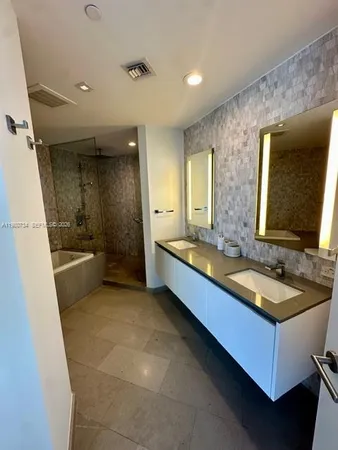 a white toilet sitting next to a sink