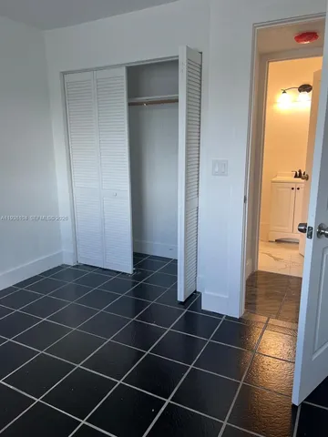 a white toilet sitting next to a shower
