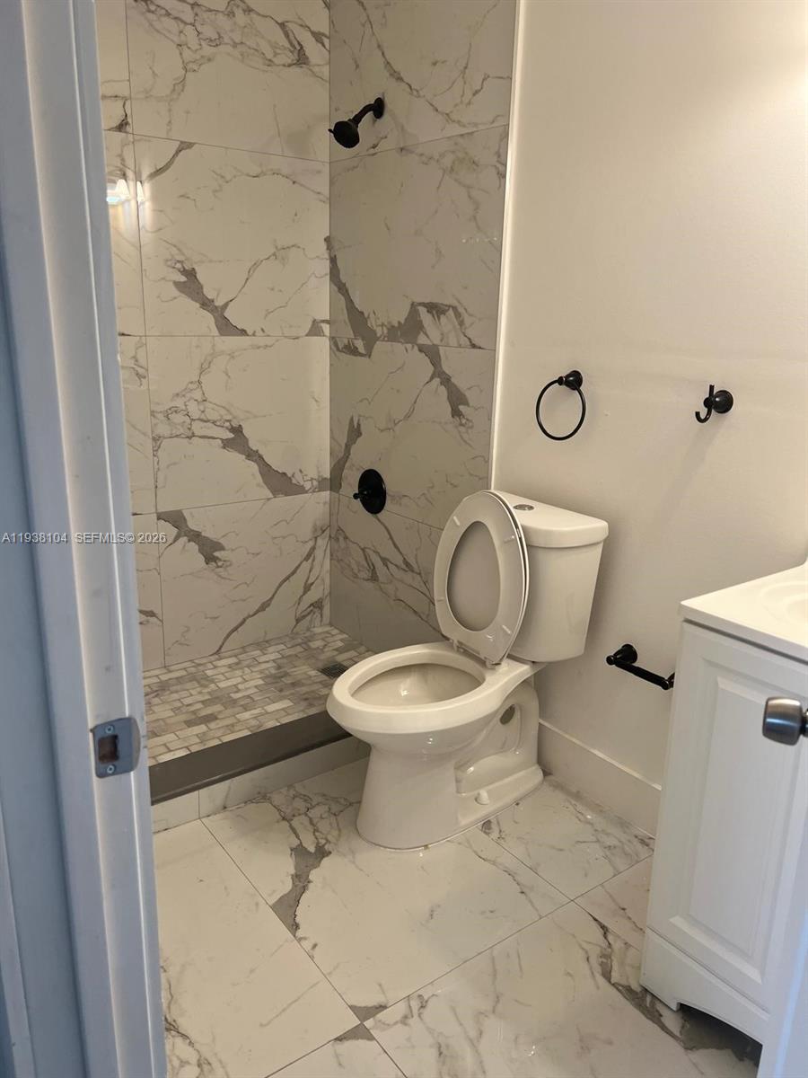 14013 Southwest 281st Terrace Homestead, FL 33033 - Photo 5 of 10 a white toilet sitting next to a shower