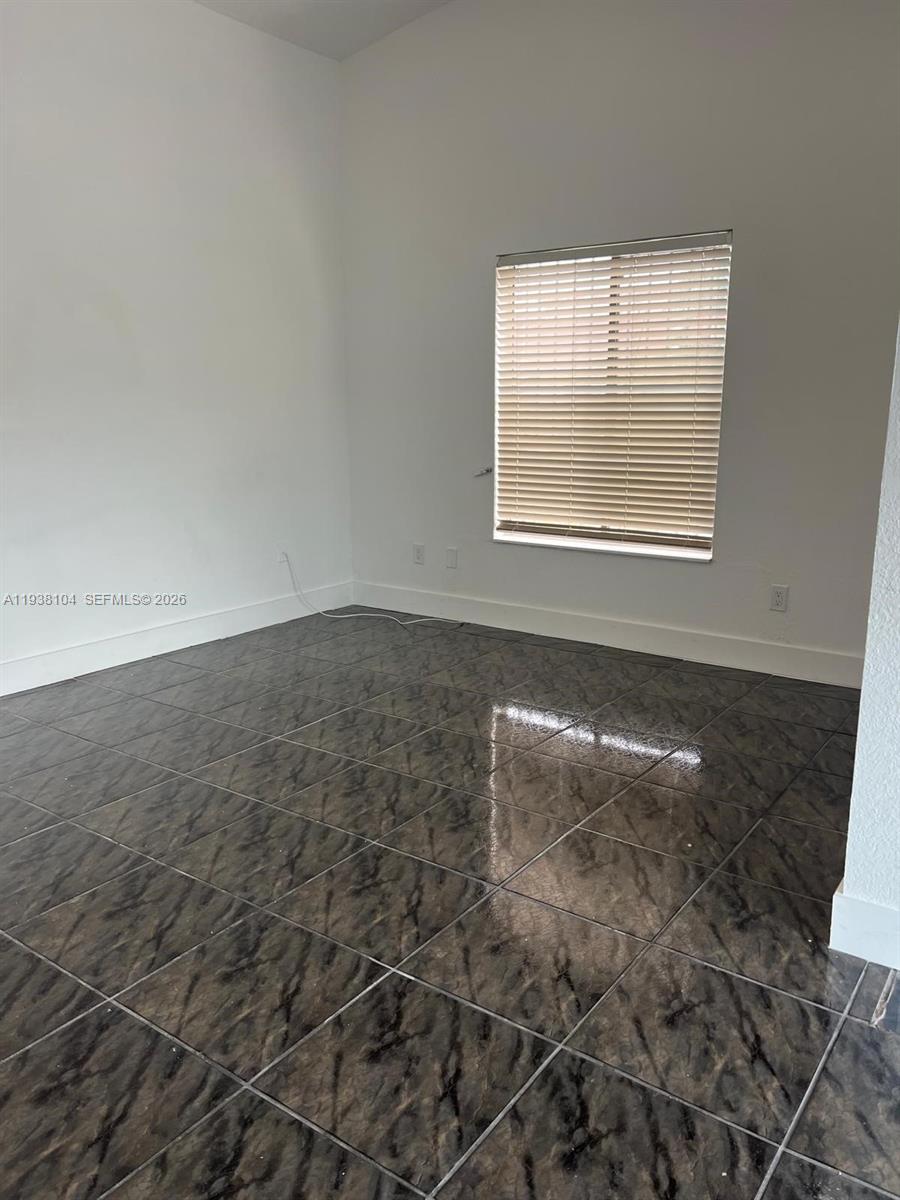 14013 Southwest 281st Terrace Homestead, FL 33033 - Photo 7 of 10 an empty room with a empty space and windows