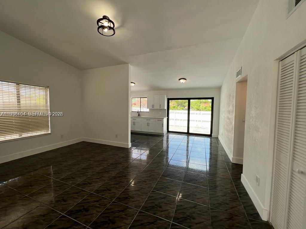 14013 Southwest 281st Terrace Homestead, FL 33033 - Photo 9 of 10 an empty room with wooden floor and windows