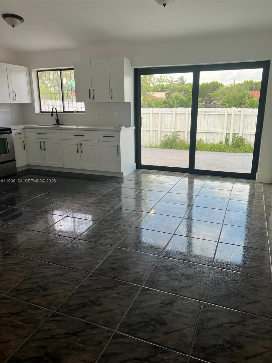 14013 Southwest 281st Terrace Homestead, FL 33033 - Photo 10 of 10 a room with lot of large windows and tiles