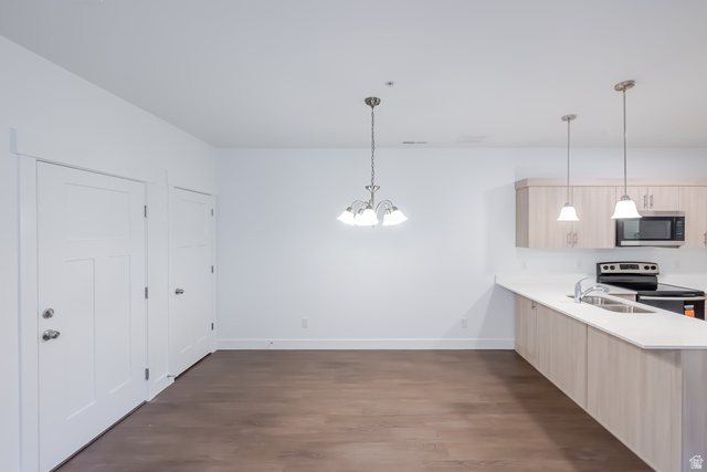 4704 Olive Avenue, Unit V202 Mapleton, UT 84664 - Photo 14 of 17 Open-concept layout with wood-finish flooring, white walls, and a contemporary light fixture