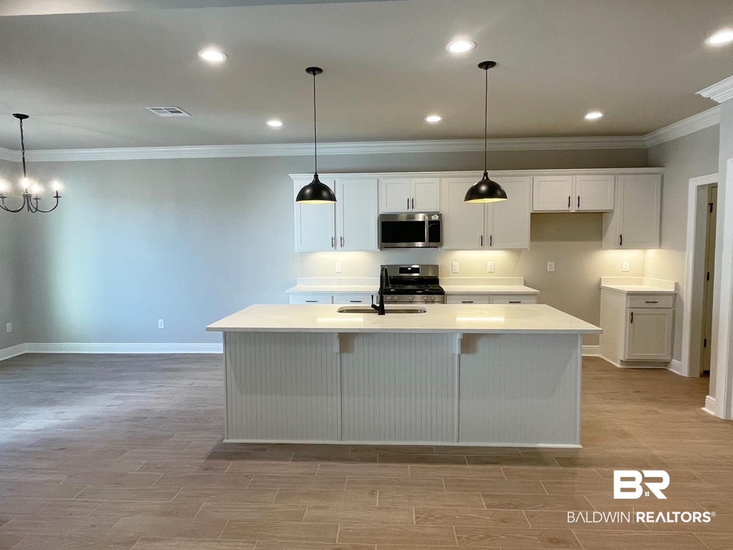 1392 Fenton Circle Foley, AL 36535 - Photo 2 of 17 Kitchen with white cabinetry, a center island with sink, decorative light fixtures, and appliances with stainless steel finishes