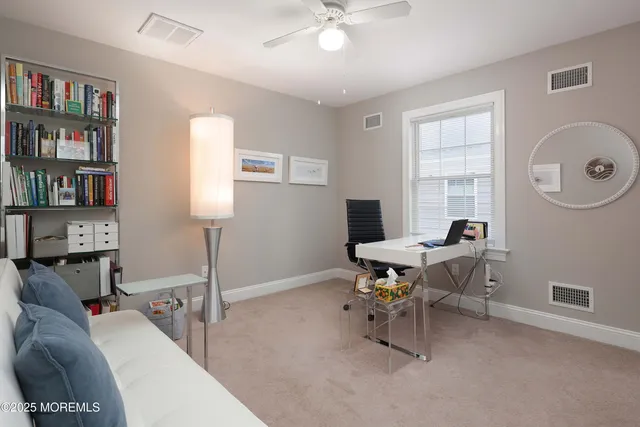 a work room with furniture and a book shelf
