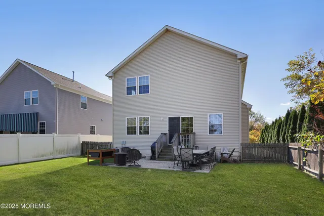 a front view of house with yard and outdoor seating