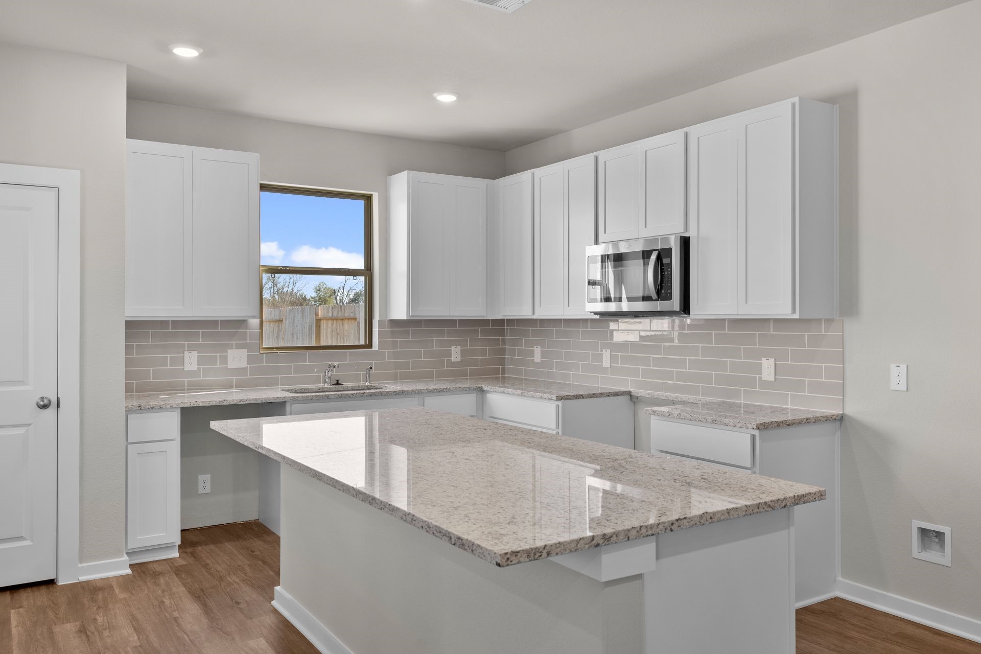 13319 Prado Rdg Lane Rosharon, TX 77583 - Photo 3 of 33 a kitchen with kitchen island granite countertop a sink a stove and cabinets