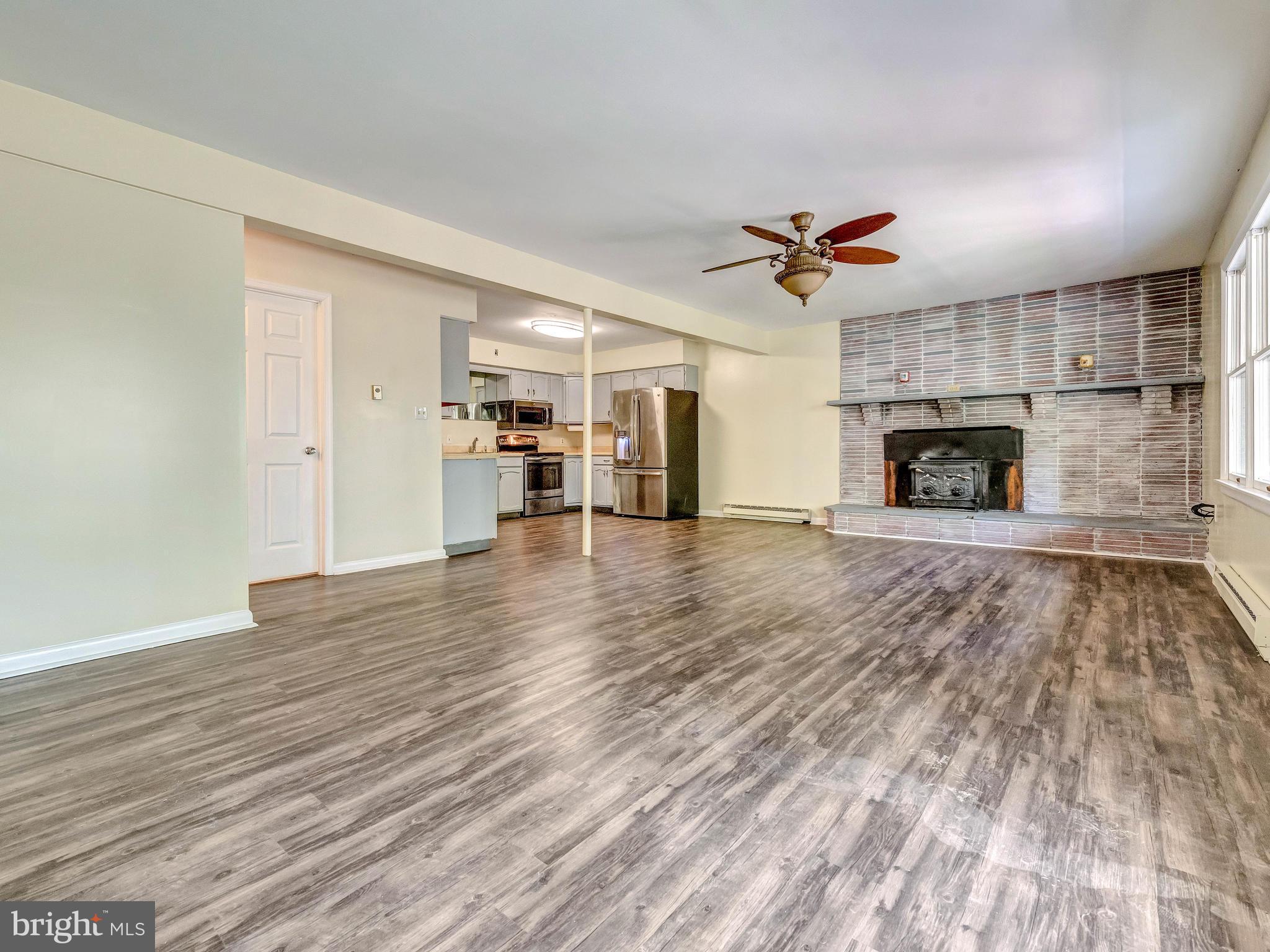 6009 Mt Phillip Road Frederick, MD 21703 - Photo 6 of 22 Living Room with open area and fireplace