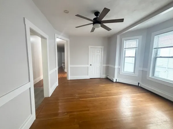 a view of a livingroom with a ceiling fan and window