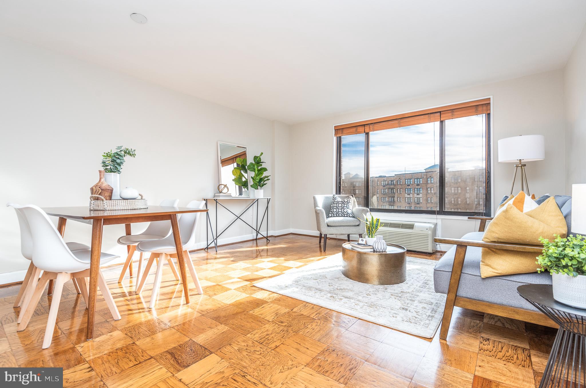 a dining room with furniture and a floor to ceiling window