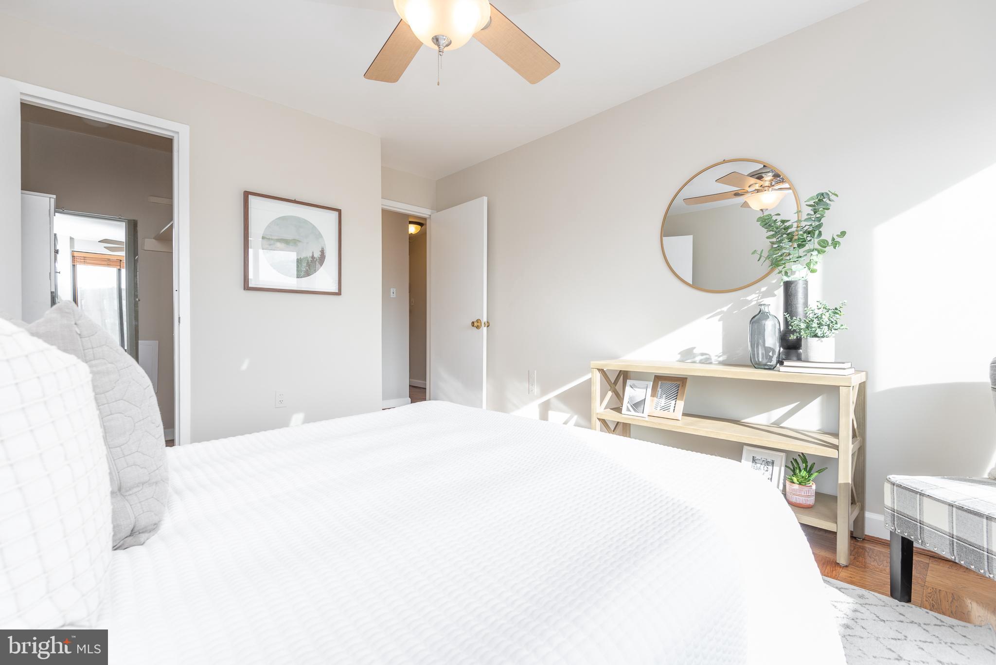 2501 Calvert Street Northwest, Unit 811 Washington, DC 20008 - Photo 11 of 28 a bedroom with a bed and a mirror