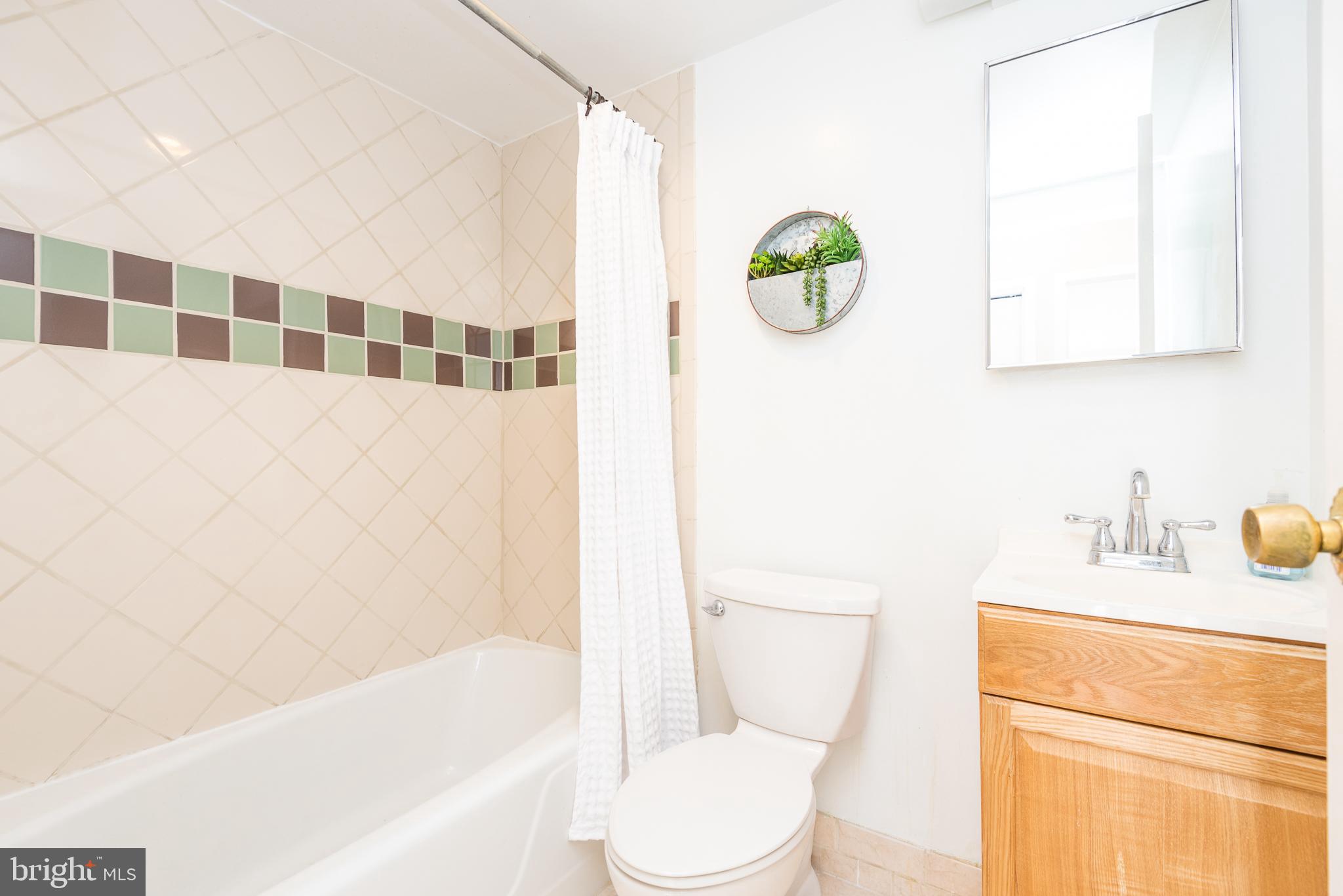 2501 Calvert Street Northwest, Unit 811 Washington, DC 20008 - Photo 12 of 28 a bathroom with a sink toilet and shower