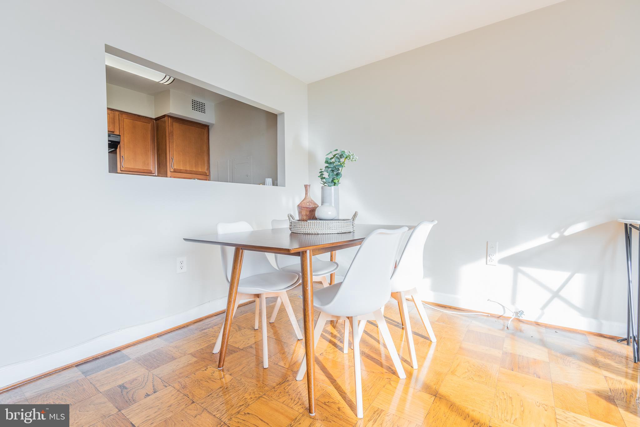 2501 Calvert Street Northwest, Unit 811 Washington, DC 20008 - Photo 4 of 28 a dining room with furniture and wooden floor