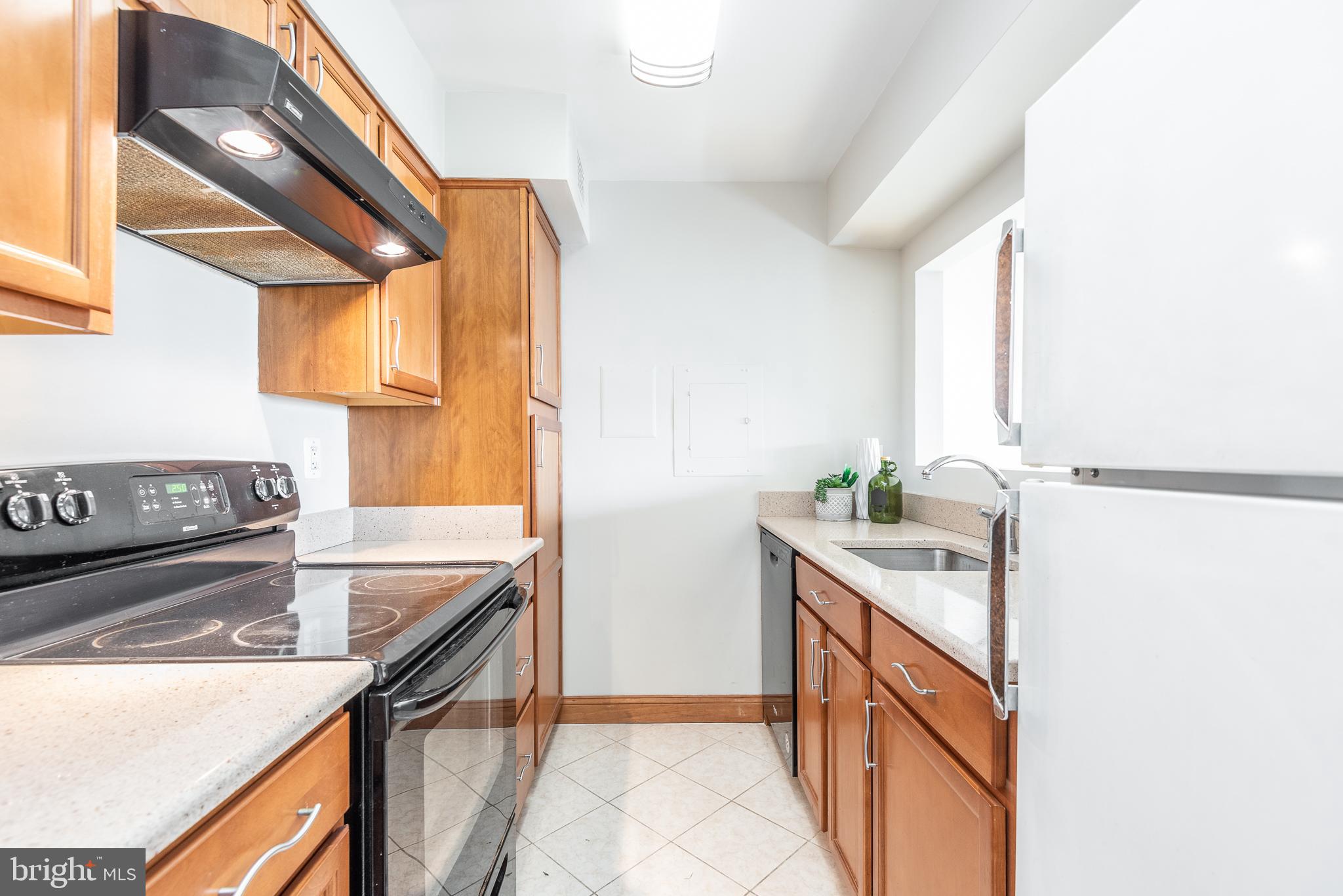 2501 Calvert Street Northwest, Unit 811 Washington, DC 20008 - Photo 8 of 28 a kitchen with stainless steel appliances granite countertop a sink and a stove