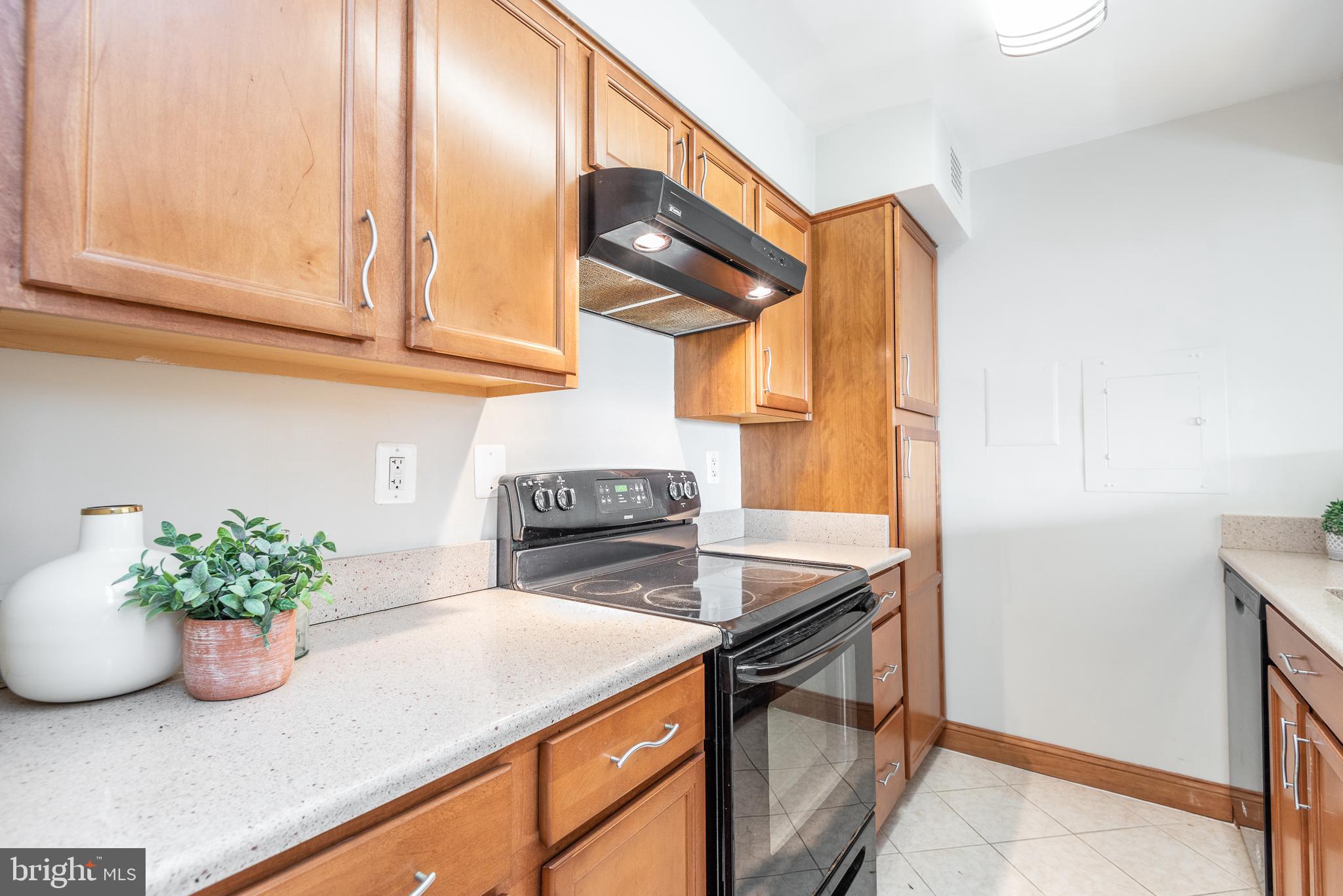 2501 Calvert Street Northwest, Unit 811 Washington, DC 20008 - Photo 9 of 28 a kitchen with stainless steel appliances granite countertop a sink a stove and a microwave