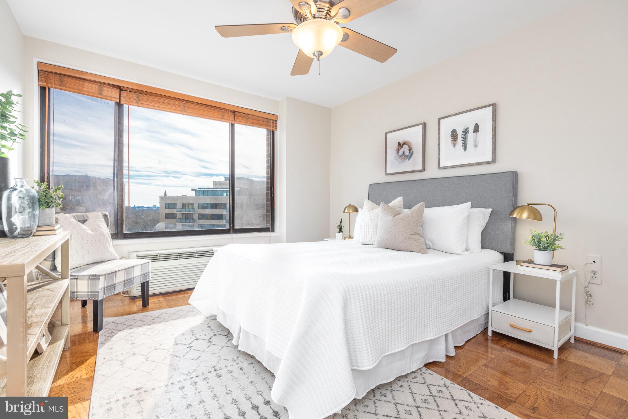 2501 Calvert Street Northwest, Unit 811 Washington, DC 20008 - Photo 10 of 28 a bedroom with a large bed and a large window