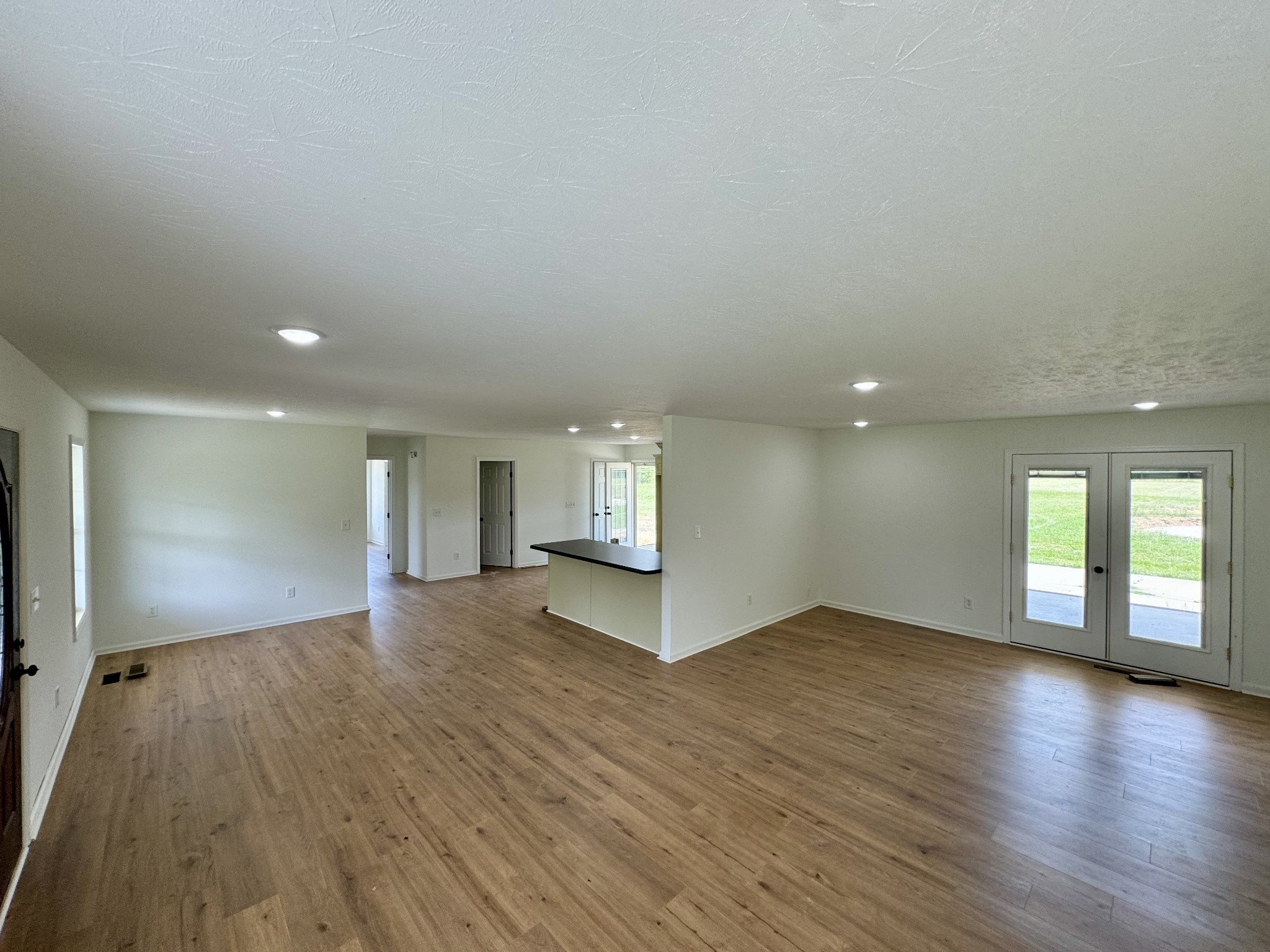 1721 Johnson Branch Road Pulaski, TN 38478 - Photo 7 of 11 an empty room with wooden floor and windows