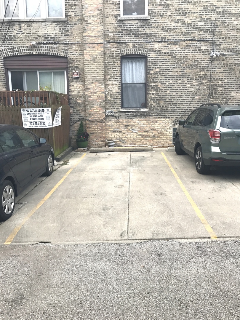 6263 North Clark Street, Unit 2 Chicago, IL 60660 - Photo 11 of 14 a car parked in front of a brick building