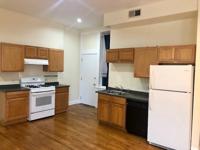 6263 North Clark Street, Unit 2 Chicago, IL 60660 - Photo 4 of 14 a kitchen with a sink a stove and refrigerator