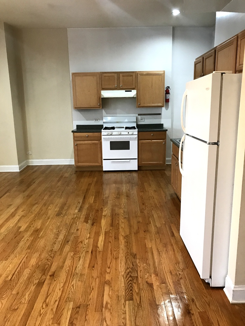 6263 North Clark Street, Unit 2 Chicago, IL 60660 - Photo 5 of 14 a kitchen with a refrigerator a stove and a sink