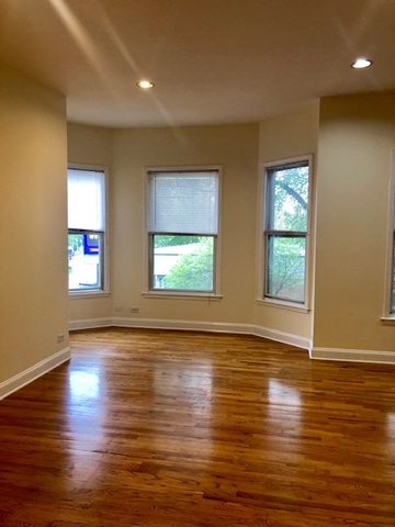 6263 North Clark Street, Unit 2 Chicago, IL 60660 - Photo 6 of 14 an empty room with wooden floor and windows